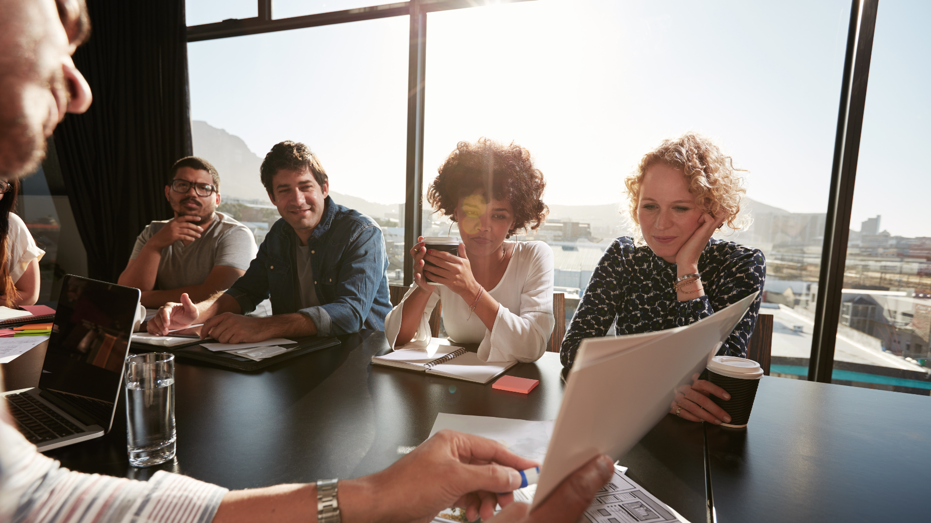 Business people in a meeting with sun beam shining in